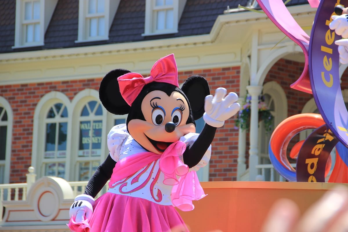 Disney character waving a welcome